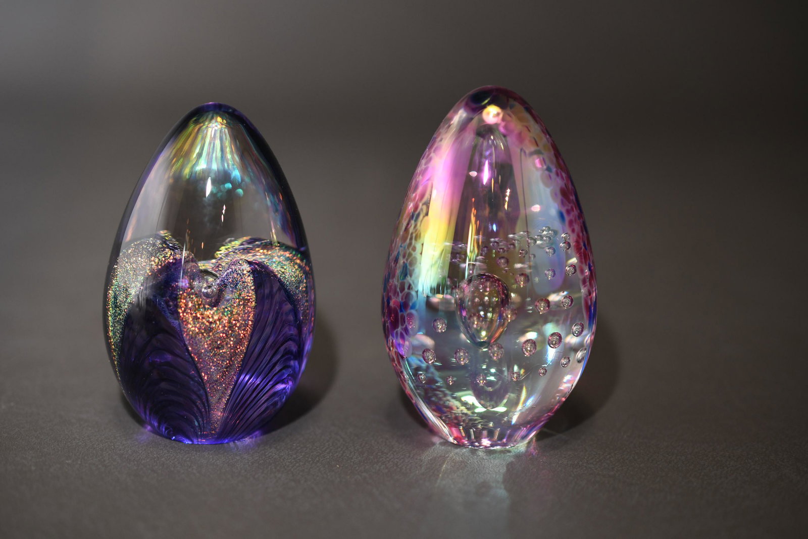 Glass Eye Studio Two Egg Shaped Paper Weights: 2" high x 1-3/4" diameter at widest point, approximate total weight 13oz