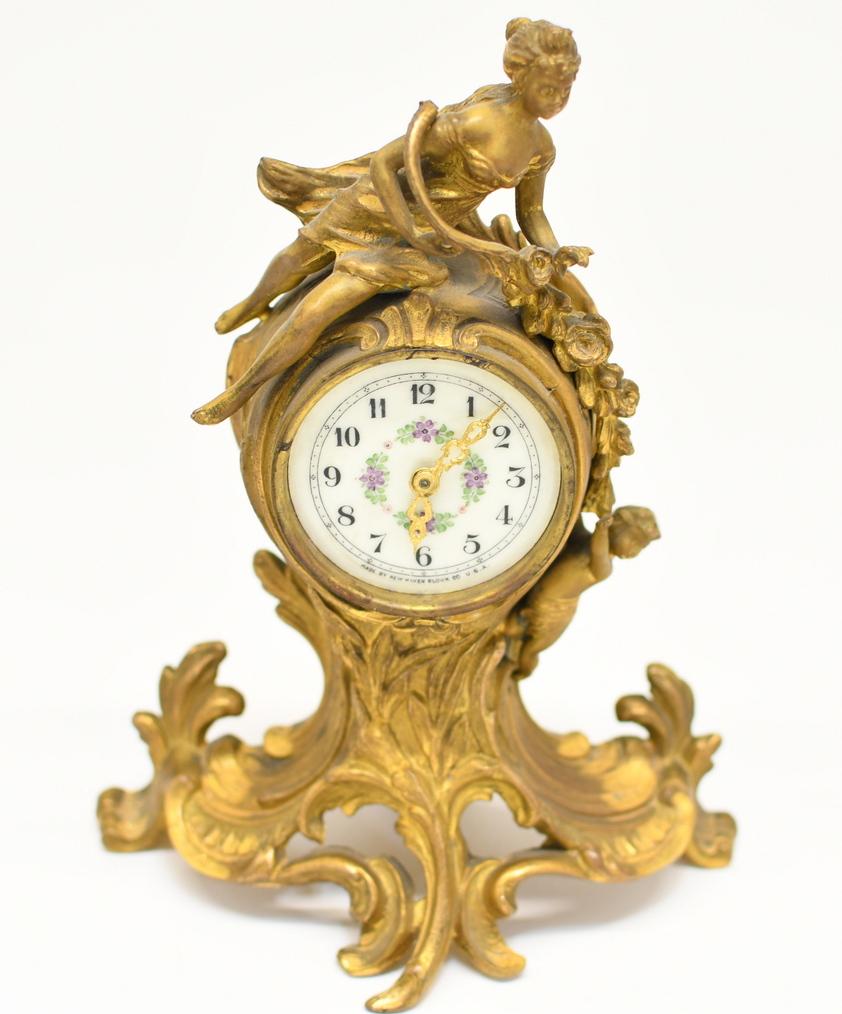 New Haven Metal Figural Clock: 10.5" tall 7-3/4 wide. Hand painted Porcelain dial, no glass, winds free, speed dial moves free. 3lb 3oz