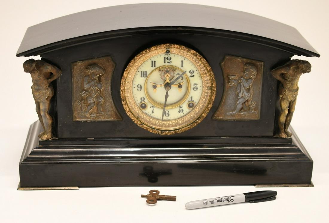 Iron Case Ansonia Mantle Clock: Wonderful working clock with porcelain dial Cherub plaques & Hercules holding up the corners. It's 17" wide x 9-1/2" tall x 6-1/4" deep, and weighs 23 lbs
