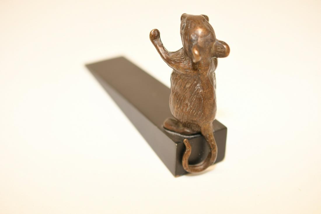 Bronze Mouse Door Stop: Bronze mouse is 3-1/2"x 1-1/2" including tail and is standing on a wood wedge 6-1/4" long, it weighs about 8 oz