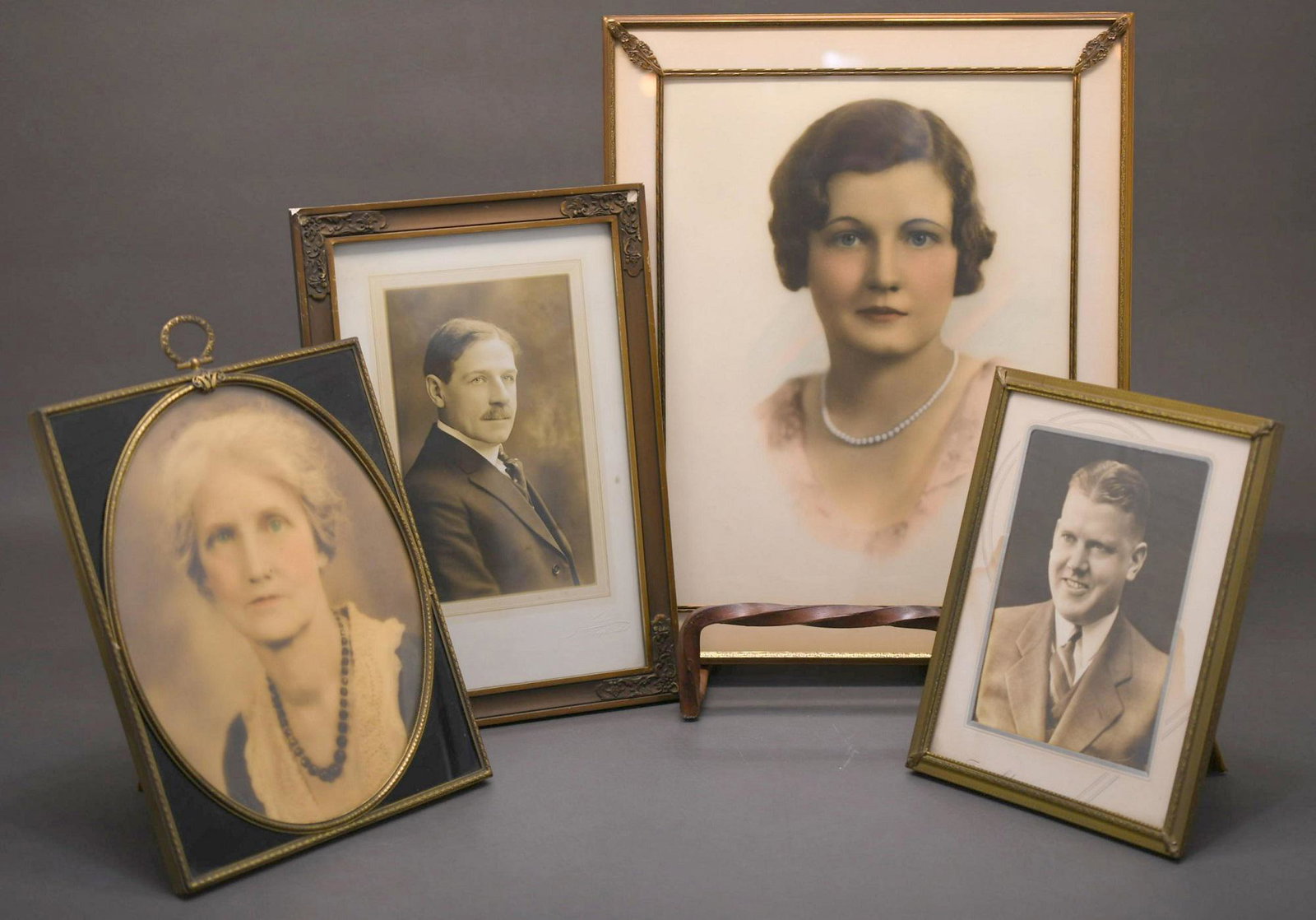 Four Vintage Framed photos: Largest is metal frame 14-1/2" x 12-1/2", next size down is wood frame by Newcomb Chicago 12-1/2" x 8-1/2", next size down has reverse painted corners black glass is metal frame 10-1/4" x 8-1/4", smal