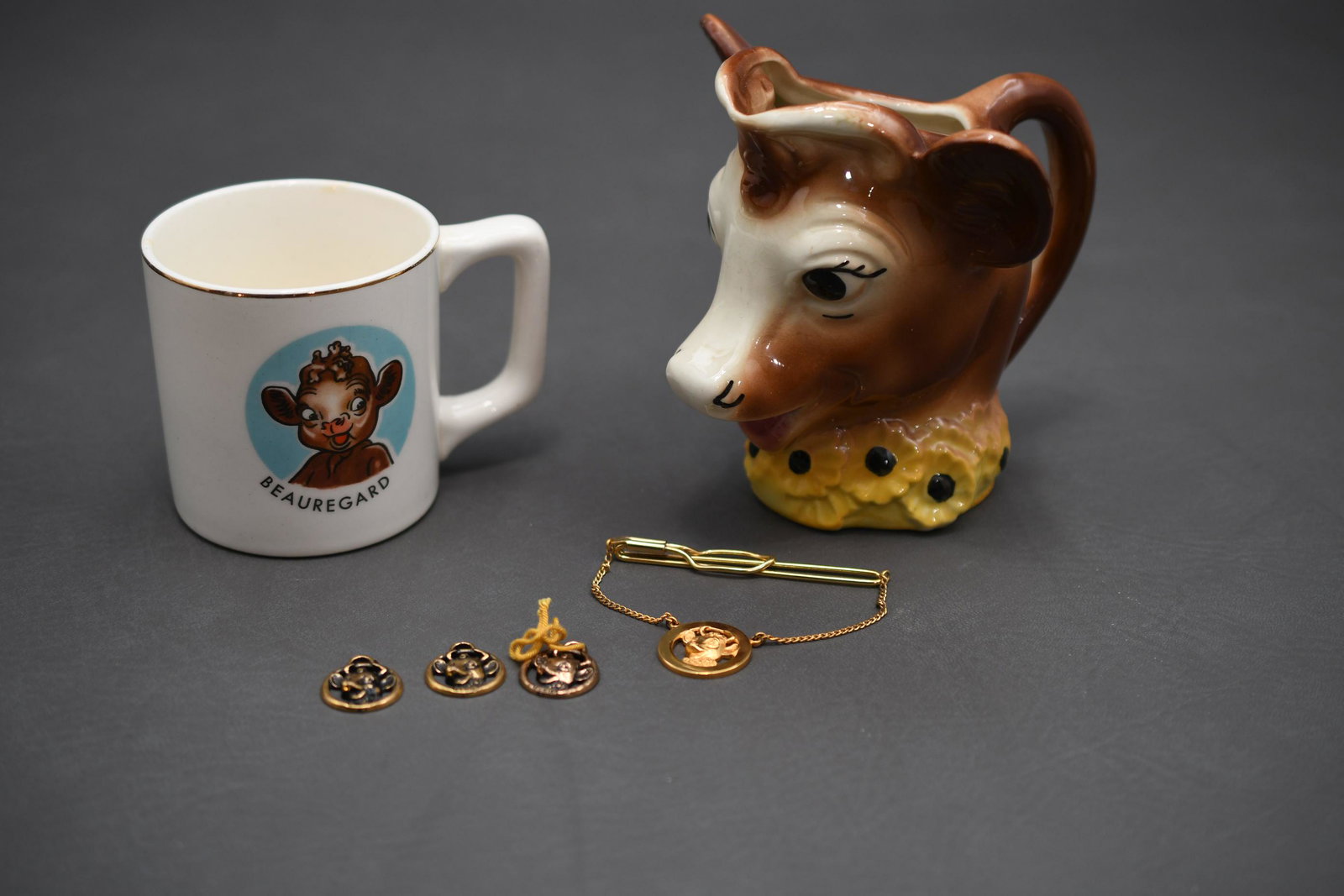 The Borden Milk Cows: Beauregard coffee mug, Elsie creamer, tie clip, 3 pendants, approximate total weight 1lb 6oz