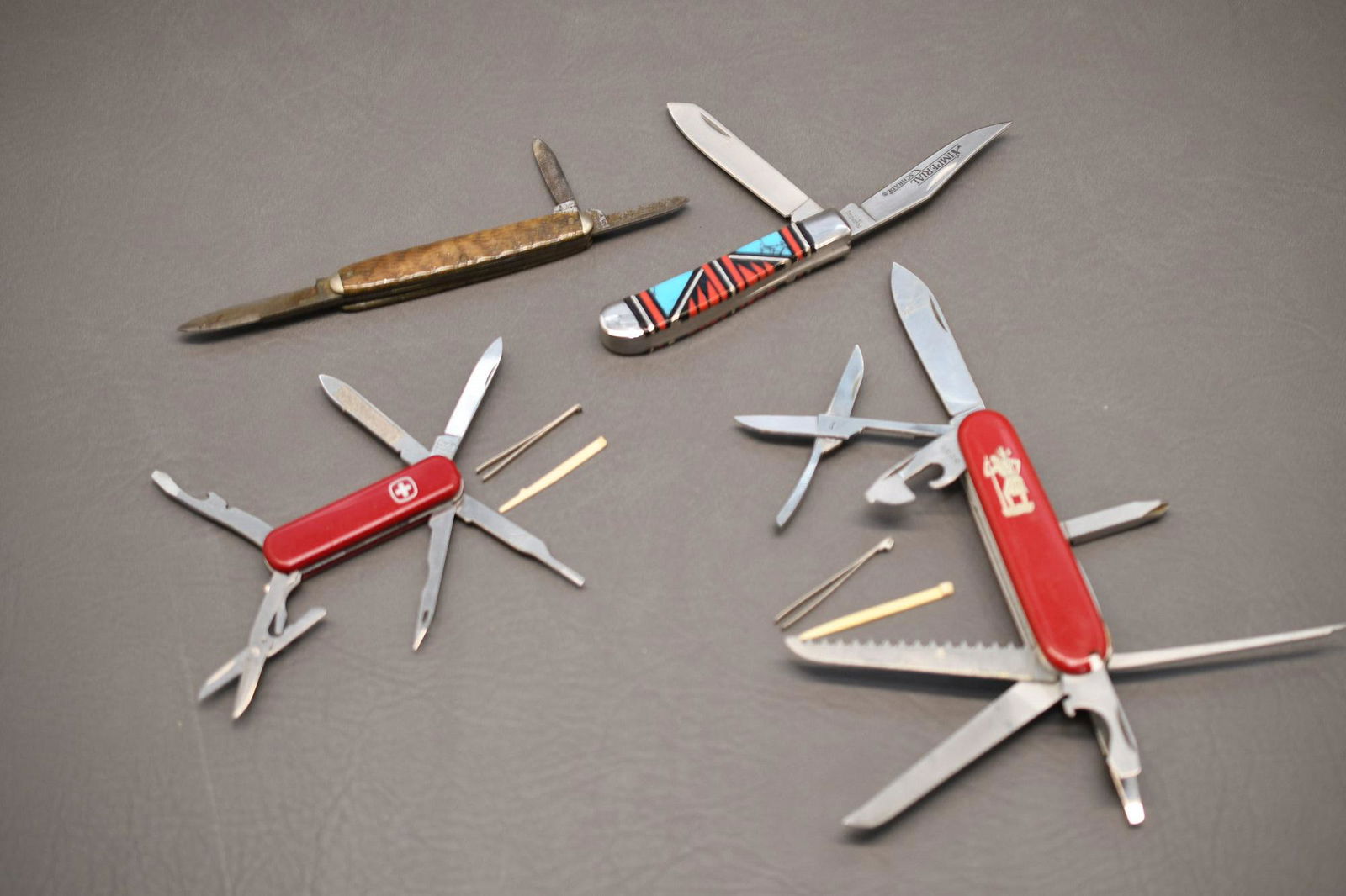 Four Pocket Knives: A.W.Wadsworth & Sons Made in Germany 3 blade, Imperial Schrade 2 blade, Victoria Officer Suisse Switzerland, Wenger Delamont Switzerland, approximate total weight 10oz