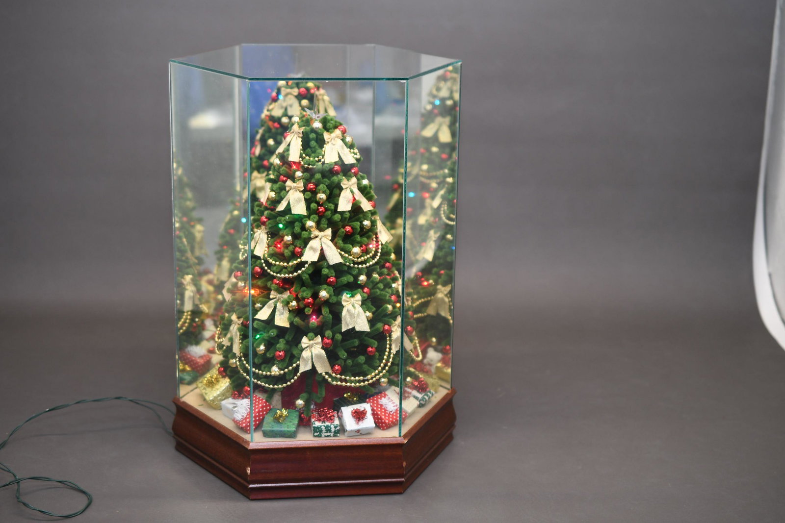 Lighted Musical Christmas Tree Display: Plug-in power chord for lights, winds for music, measures 17-3/8" tall x 10-1/2" diameter, approximate weight 10lbs