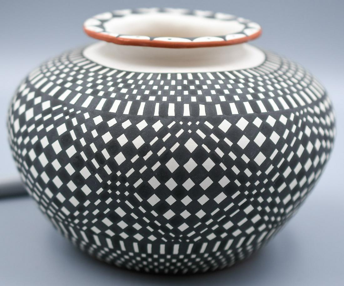 Acoma, NM, White and Black Patterned Jar, M. C. Antonio: 4-1/2 inches tall with 6 inch diameter, This one is difficult to tell if it's green pottery or hand coiled it looks like there may be a mold seam. But beautifully decorated.