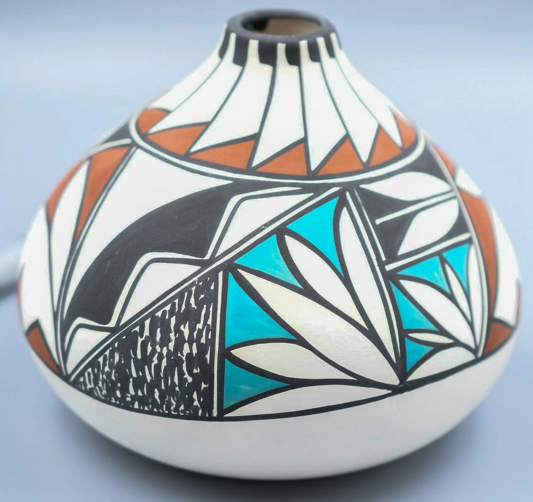 White Floral Geometric Vase with Black, Aqua, and Brown, Albert Alvidrez (Tigua): 5 inches tall with 6 inch diameter, this appears to be green pottery but we are not positive, it's difficult to tell.