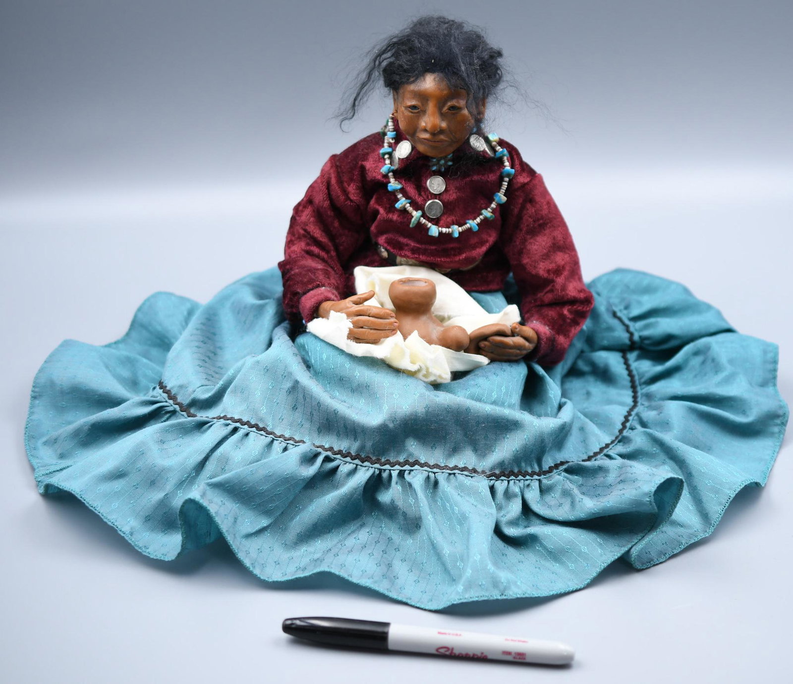 Potter doll with blanket, sitting pillow, and jar (four pieces), Loretta Dawn Byrne: Doll: 8 inches tall by 7-1/2 inches by 7 inches (skirt naturally spreads out beyond these dimensions to 12 inches by 13 inches). Jar: 2-1/2 inches by 2-1/4 inches by 1-1/2 inches. Rug: irregular diame