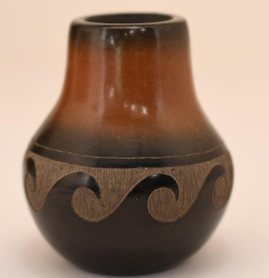 Santa Clara, Black and Tan Jar with Carved Waves, Corn Moquino: 3-1/2 inches tall with 3 inch diameter
