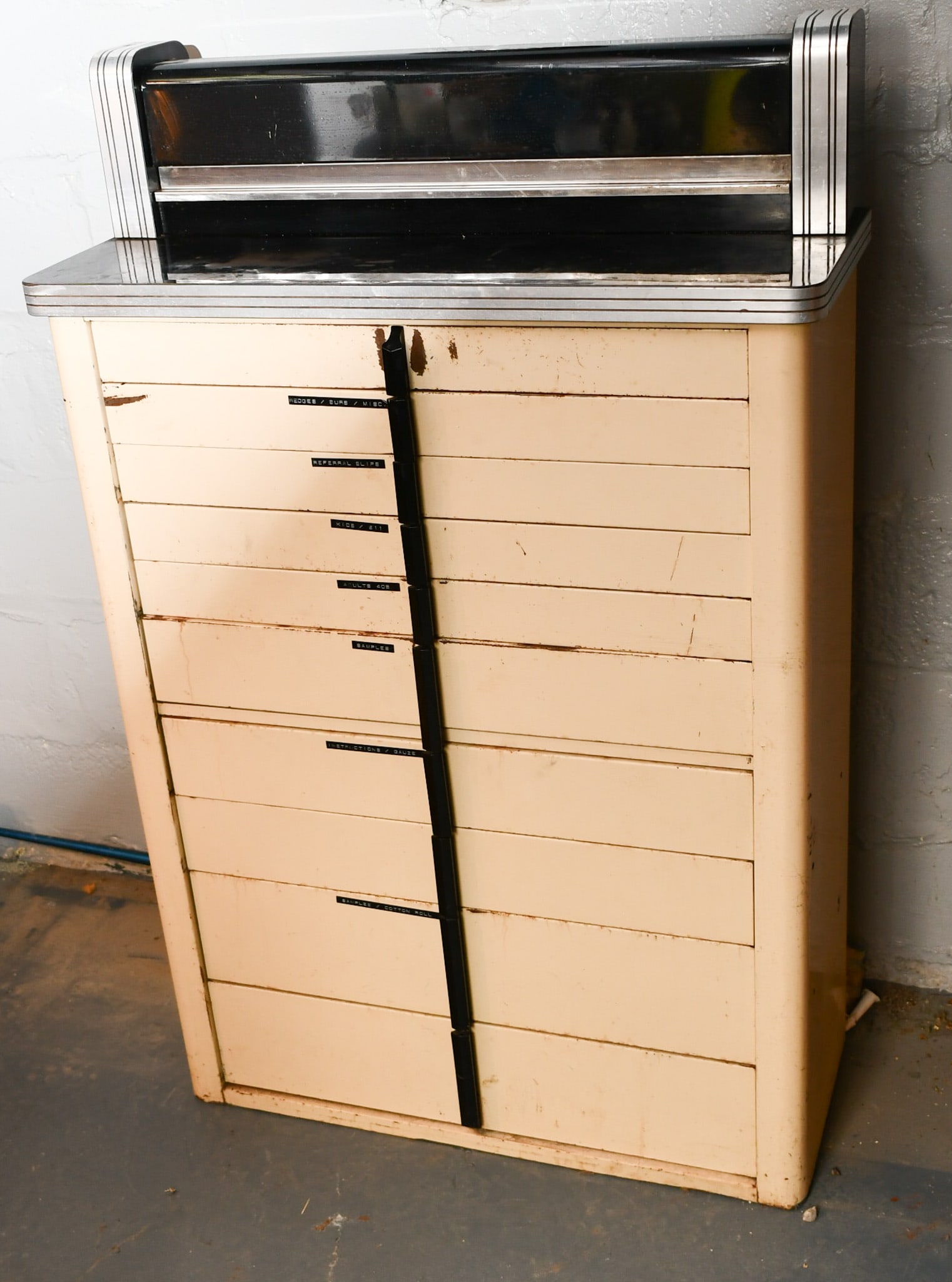 Art Deco Dental Cabinet: Used as a tool storage, all metal body and drawers. The top storage is metal painted black. Drawer pulls appear to be Bake-Lite. Base sits flat to floor. READ OUR SHIPPING POLICY'S! This will be In pe