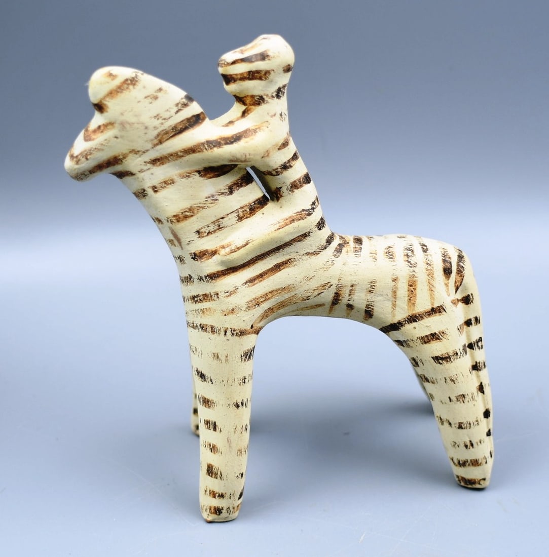 Benaki Horse and Rider: Benaki of figurine of horse and a ride. The light color leads us to believe it's a replica of the original from a Boeotian workshop(600-550 BC). Total height-6". Body-3 3/4". 2 1/2"W. Weight-10oz. (NO