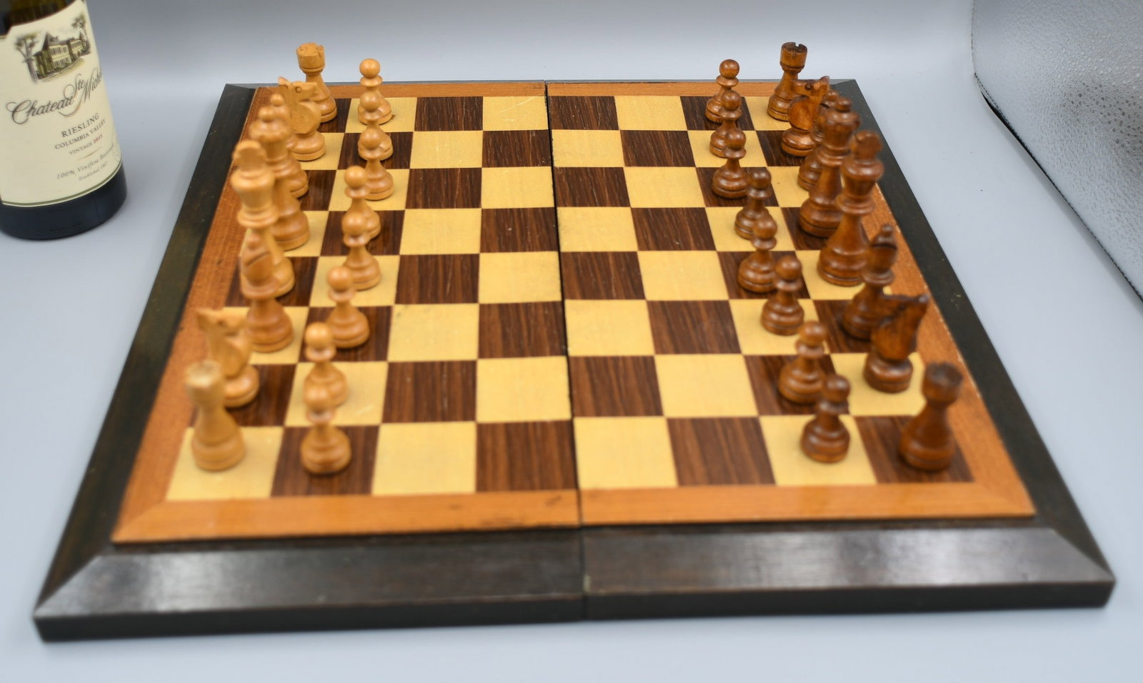 Chess set: contemporary folding chess set with magnetic catch. Soft wood chess pieces. Board is inlayed squares and border. (NOTE-Weight and dimensions are before packaging) Board dimensions-15 3/4" x 16". King 