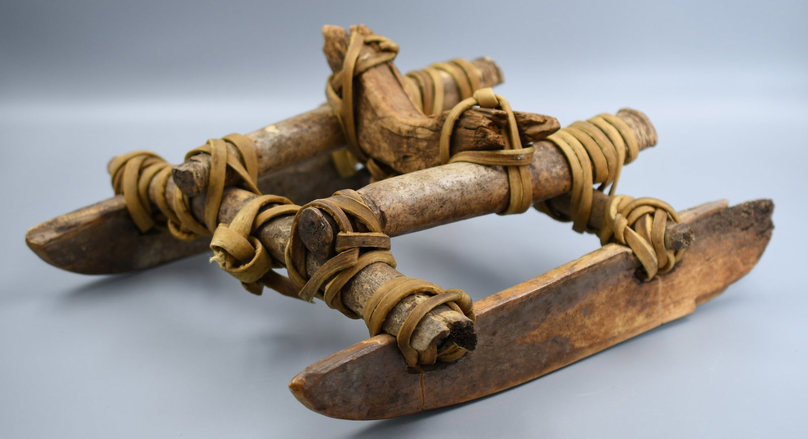 Inuit Bone Sled: Inuit bone sled with animal skin strapping. (NOTE-Weight and dimensions are before packaging) dimensions- 14"x 13"x 6 1/2". Weight- 5lbs 6oz.