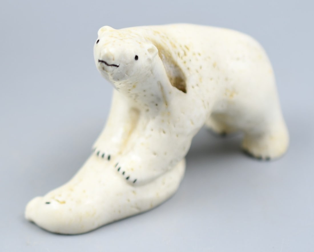 Inuit Bone Carving: Inuit bone carving of a polar bear stepping on a seal. (NOTE-Weight and dimensions are before packaging) Dimensions- 3 3/8"L. 2 1/4"H. approx. 1"W. Weight- 3.35oz
