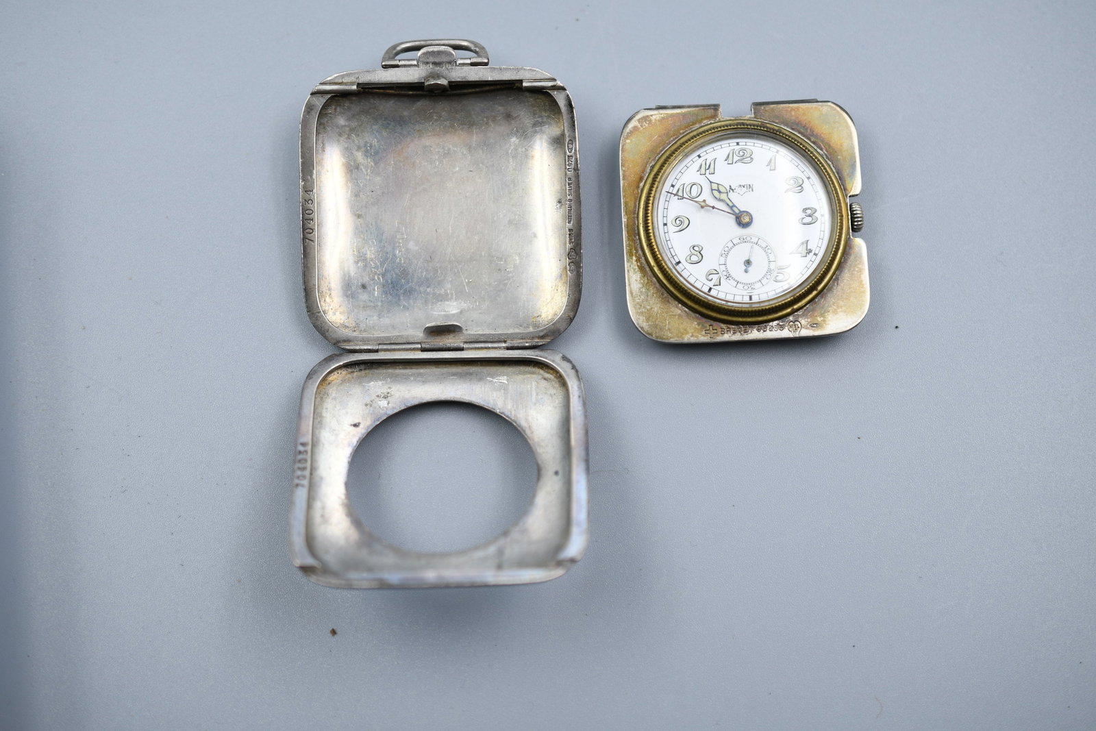Vintage Sterling Pocket Watch: Art Deco Sterling silver outer case with working gun metal watch. Weight- 2.05oz. 1 3/4" x 1 3/4". Face dia.-1 1/8". (NOTE-Weight and dimensions are before packaging)