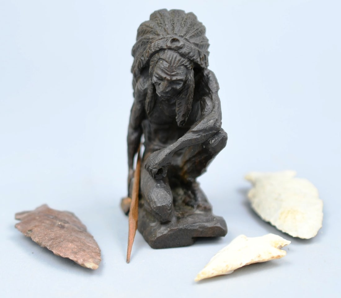 Native American Carving and arrow heads: Miniature detailed carving of an Indian chief in hardwood with removable spear. 3 arrow heads. (NOTE-Weight and dimensions are before packaging) carving- 2 1/2"H. base- 1"x 1 3/8". Weight- .8oz. Arrow