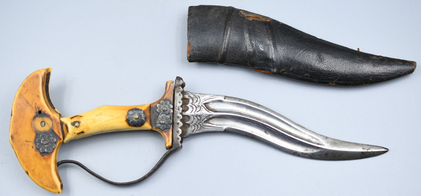 17th Century Hindu Dagger: 17th century Iron with Ivory, wood and leather sheath . Aged patina. (NOTE-Weight and dimensions are before packaging) blade-5"L. total length-9 1/4". Weight- 5.7oz.