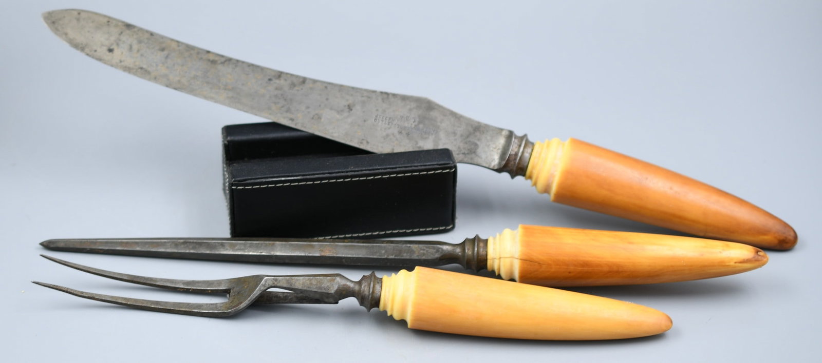 Antique 3 piece Cutlery Set: Cutlery set by Joseph Rodgers and sons. Appointed by her majesty as the royal cutlery maker. Hallmarked Victoria Regina Ca. 1880. Handles are walrus Ivory. Knife, Sharpener, and carving fork. (NOTE-We