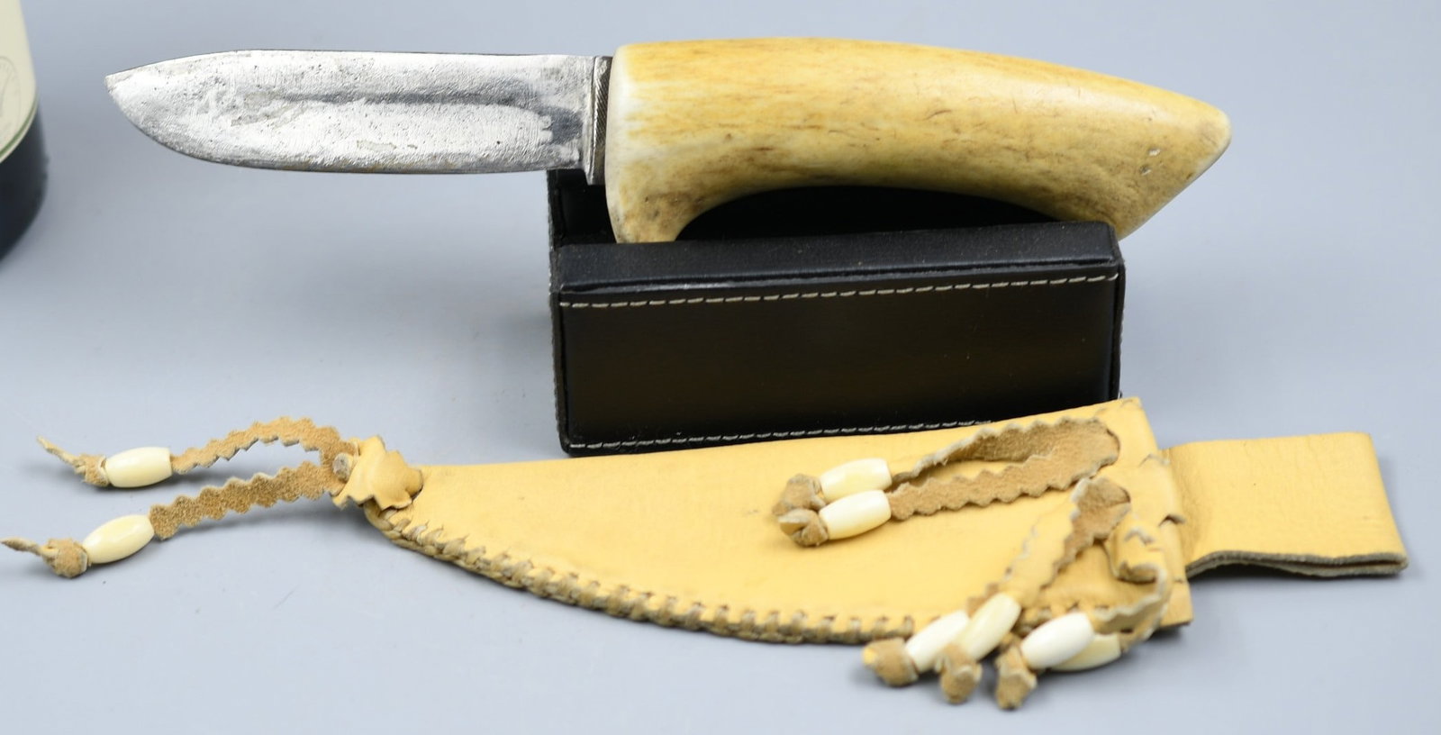 Handmade Knife: Steel blade and antler handle, Leather sheath. (NOTE-Weight and dimensions are before packaging) Handle-4 1/2". Blade-3 3/4". Total weight- 4.75oz.