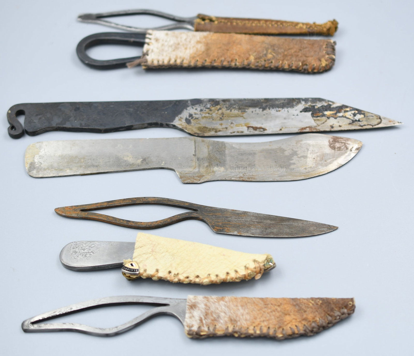 Hand forged knife group: 7 hand forged knives, 4 Damascus steel, 4 with sheaths(2 leather,2 animal hide) (NOTE-Weight and dimensions are before packaging) Lengths range from 4 1/2"-11". See photos. Total combined weight- 1lb 