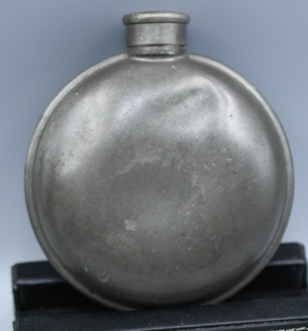 Pewter Flask: Round Pewter flask with screw on top. (NOTE-Weight and dimensions are before packaging) Flask Dia-3 1/2". 4" from lid to bottom. Weight-4.35oz.