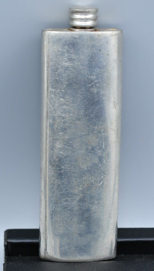 Comoys Boot Flask: 4oz English Pewter boot flask made in London England. (NOTE-Weight and dimensions are before packaging) 4oz flask. 6 1/8"L x 2"W x 5/8"D. Weight-3.85oz.