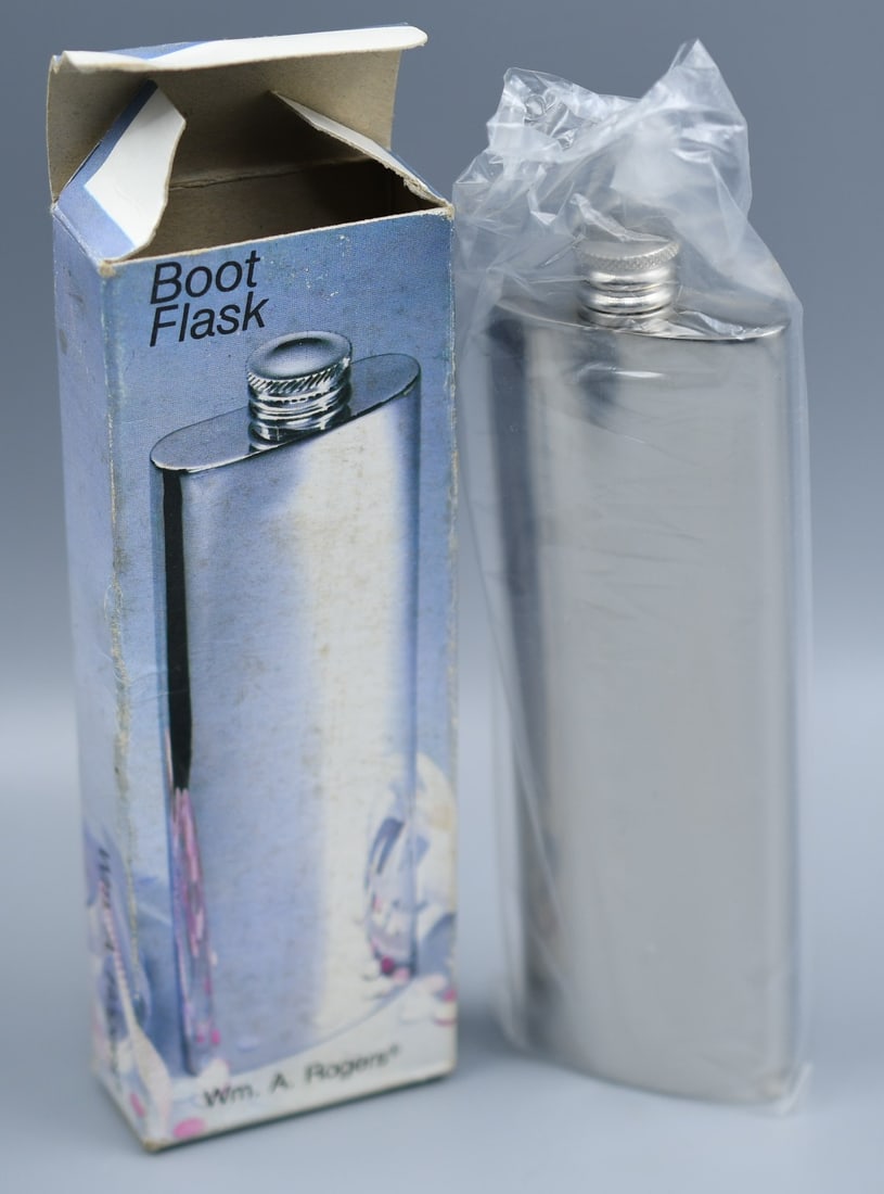 Wm A. Rogers Boot Flask: Brand new, still in bag and box. Wm A. Rodgers boot flask (011 9520). Stainless Steel 3 1/2oz capacity, screw top. (NOTE-Weight and dimensions are before packaging) 3.5oz flask. Dimensions-6"L x 2"W x