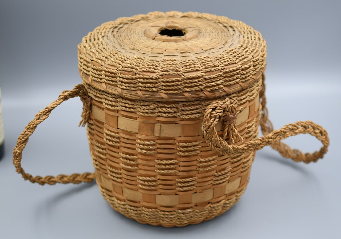 Basketry: Woven basket with lid and handles. (NOTE-Weight and dimensions are before packaging) Base dia.-6". Top Dia.-8.25". 8.5"H. 8.25Weight-7.15oz.