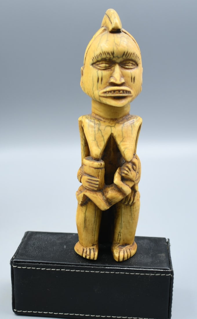 Antique African Bone Carving: African Bone Carving of human figure. (NOTE-Weight and dimensions are before packaging) Dimensions-1"W x 1 1/4"D x 5 3/4"T. weight- 2.55oz.