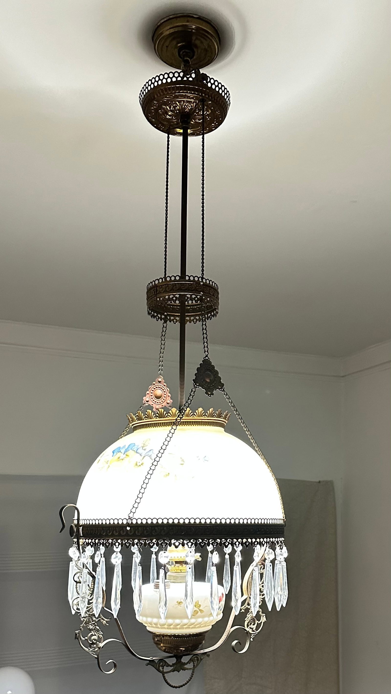 Antique hanging oil lamp: This has been converted into an electric lamp. This will be disconected once it's been paid for. Pickup or shipping is available but we can't give a quoate until it's taken down.
