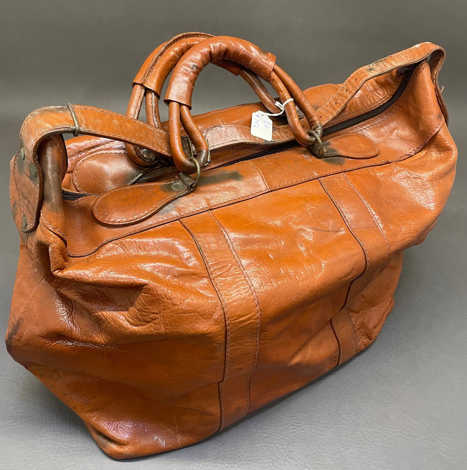 Vintage Leather Duffle Bag: Large brown leather tote bag. No make name. Inside is lined with a soft gold felt. 9"W x 18"L x 16"D.