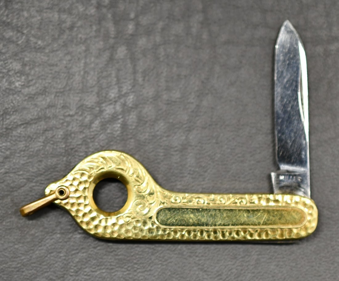 Cigar Cutter/Pocket Knife: Miller Brothers USA gold tone engraved lightly used cigar cutter with folding 1.5" blade knife. Dimensions given are for the item(s) & weight is with the packaging.