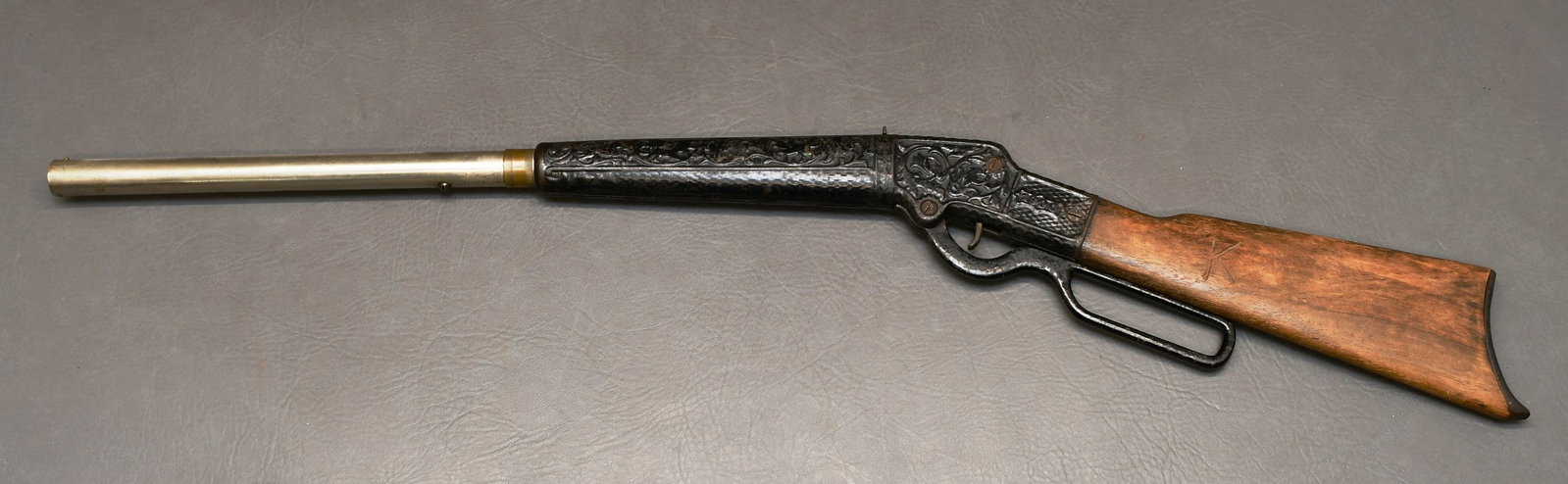 Columbian Bailey 1900 Type 2 Air Rifle, Pat Oct 24, 1893: "See photos" 1000 shot air rifle has a wood stock with cast metal embossed 1900 & floral design with Stagg & 8 other game animals. Nickel plated barrel with brass shot tube, and cast metal butt plate.