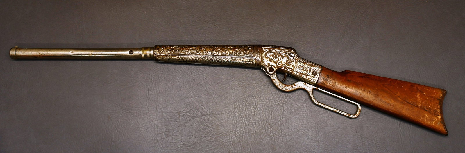 Columbian Bailey 1908 Nickel Plated Air Rifle, Pat Dec 8, 1908: Pat Dec 8, 1908 is printed under Oct 24, 93. This rifle has a wood stock with cast metal embossed 1908 & floral design with Stagg & 8 other game animals. It is embossed Columbian on the side of the Fo