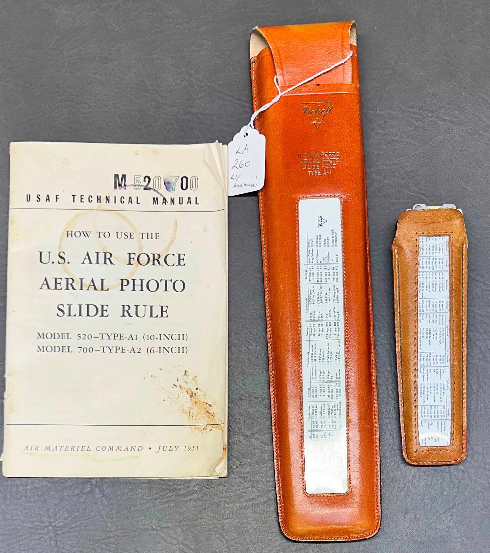 2 U.S. Air Force Aerial Photo Slide Rules Type A-1 & A-2 by Pickett: U.S. Air Force Serial Photo Slide Rule Type A-1 & pocket slide rule A-2 by Pickett in leather case & includes USAF Technical Manual published 1951. This came from the same estate as the Pilot helmet.