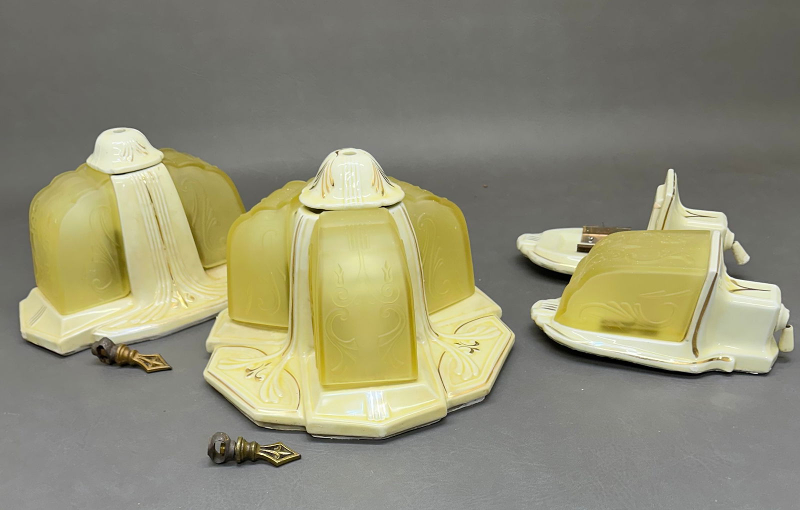 Antique Art Deco Uranium Glass Light fixtures: "One 3 shade porcelain ceiling fixture 12" x 12" x 7", one 2 shade ceiling fixture 12" x 7" x , and one single shade wall sconce 9" x 4.25" x 4", plus one wall sconce missing shade, the last image no