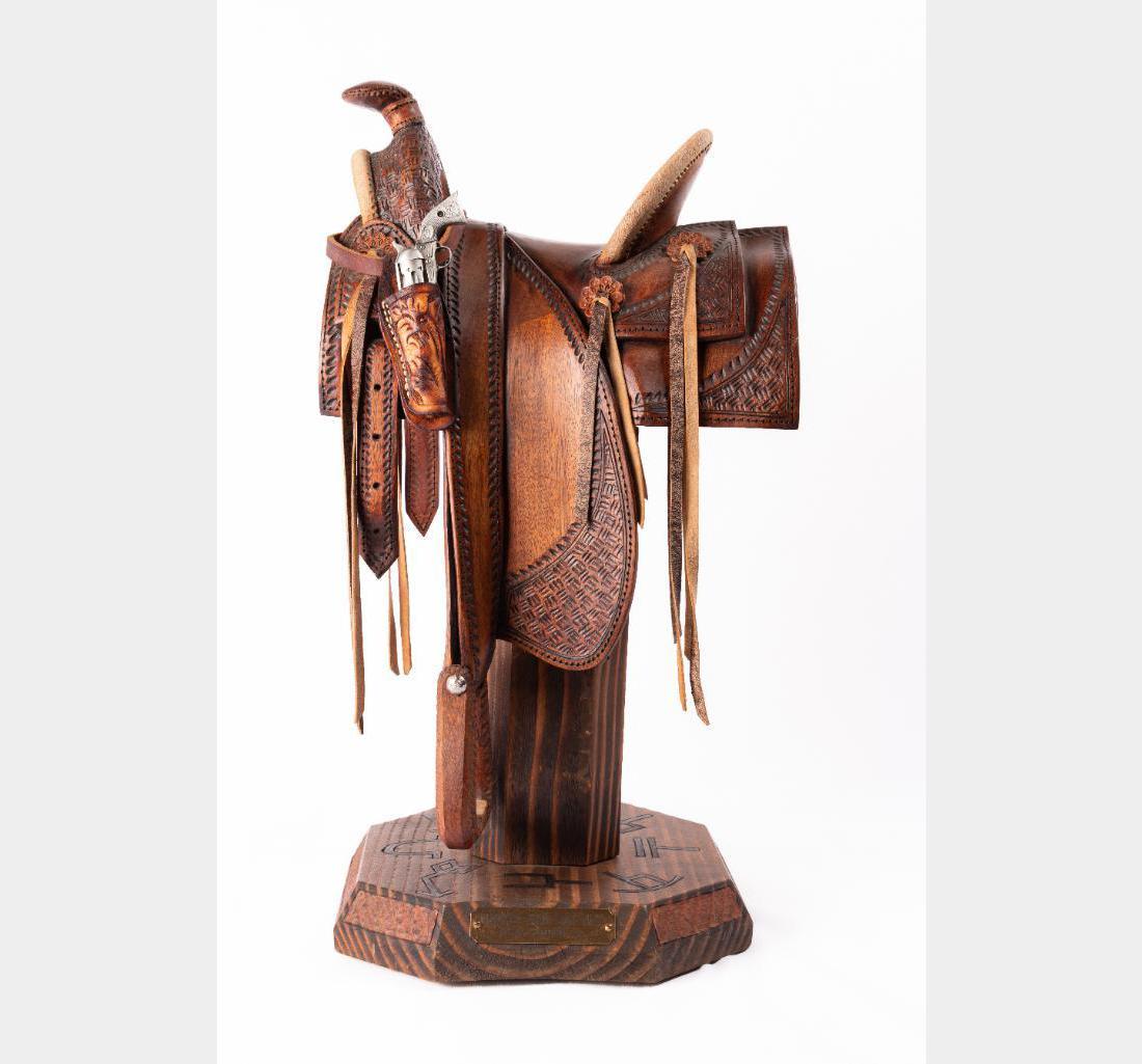 William M. Churchill Jr., hand-carved wooden saddle: William M. Churchill, Jr. (1936 - ) Narrow Fork-Half Seat 19" x 11" x 8" hand-carved wooden saddle Inscribed: Bill Churchill 2005. $2,000-3,000 Provenance: Private Collection, Montana.