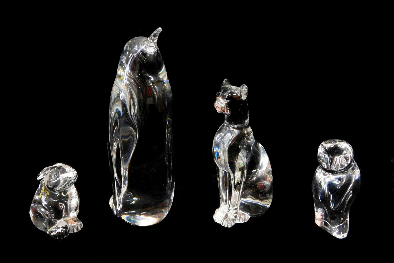 Baccarat crystal animal figures, 20th C., all signed,: Baccarat crystal animal figures, 20th C., all signed, including: cat, small chip to ear, 6 ¼" h.; an owl, 4 ¼" h.; and a rabbit, nick to toe, 3" h.; along with a Daum glass penguin, 8" h., all piece