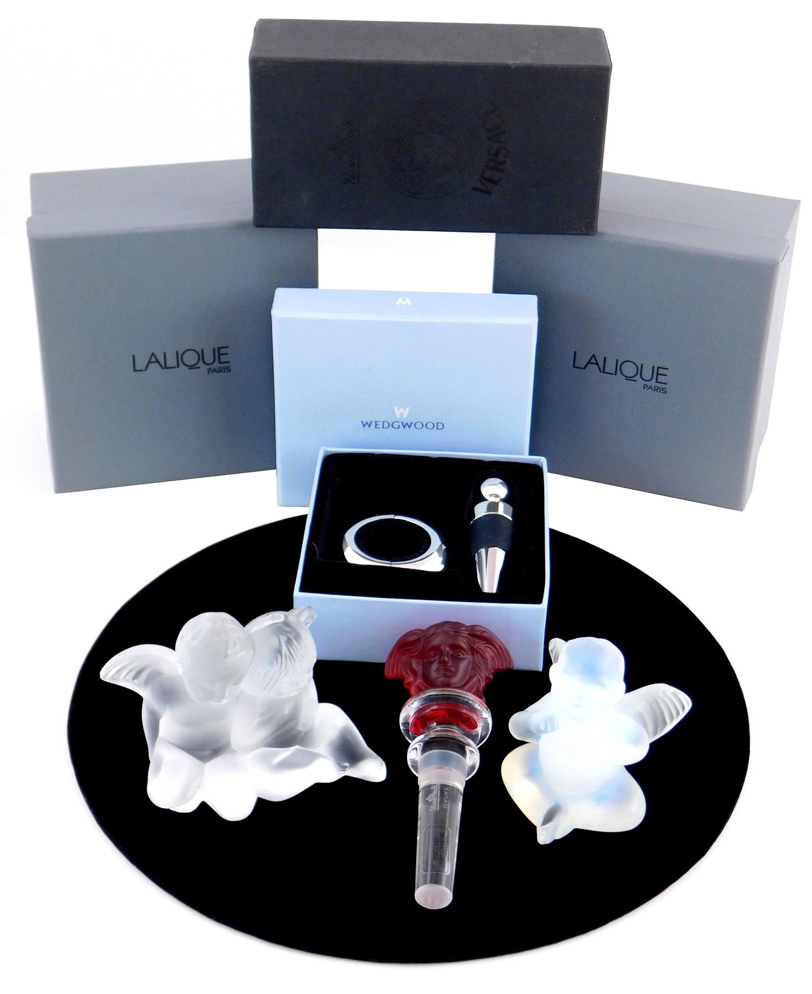 GLASS: Versace, Lalique and Wedgwood, four pieces in: GLASS: Versace, Lalique and Wedgwood, four pieces in original packaging, pieces include: Rosenthal Versace "Medusa Head" crystal stopper in red, 5 1/4" l.; two Lalique angel figures, "Capriccio Opal A