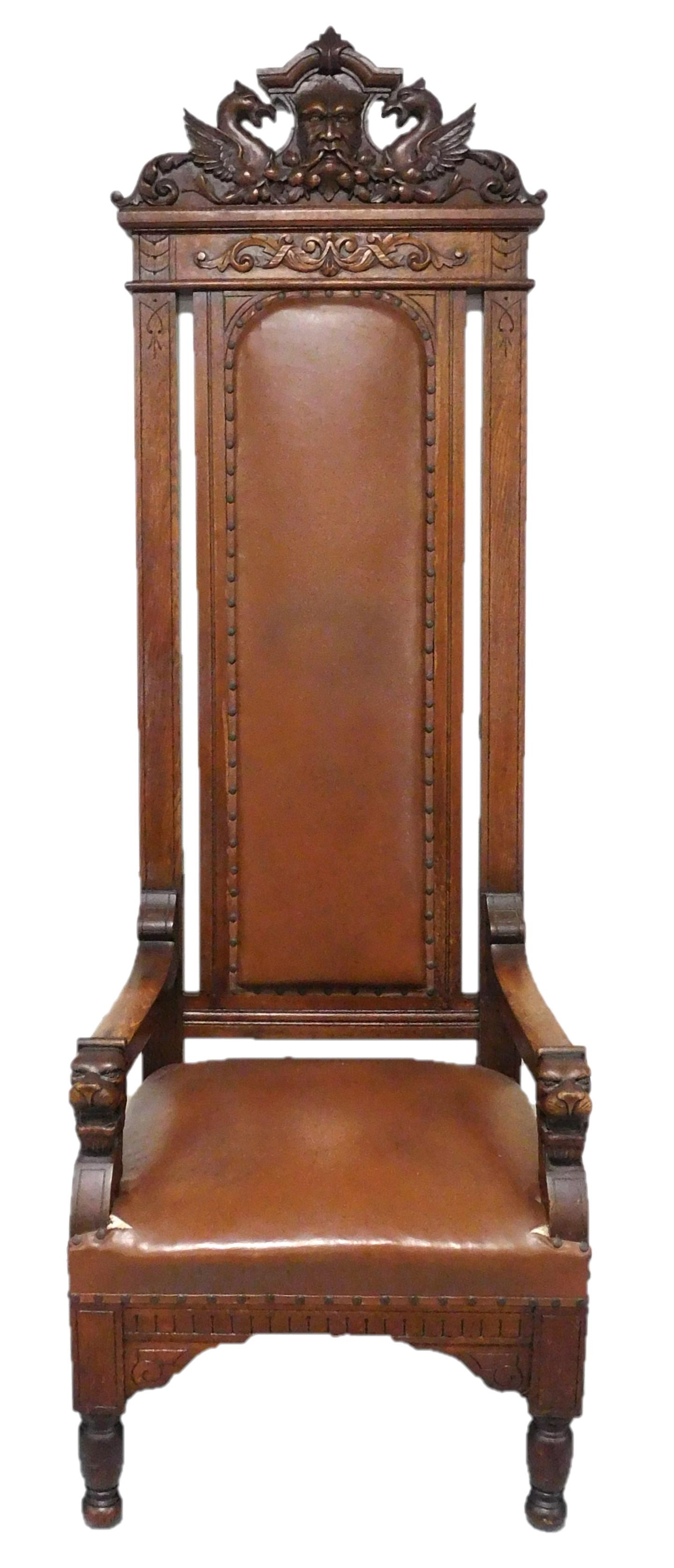 Monumental Renaissance Revival throne chair with masque: Monumental Renaissance Revival throne chair with masque and griffin carved crest, late 19th C., dark mahogany stain, elaborate carvings throughout, wear consistent with age and use including tears in 