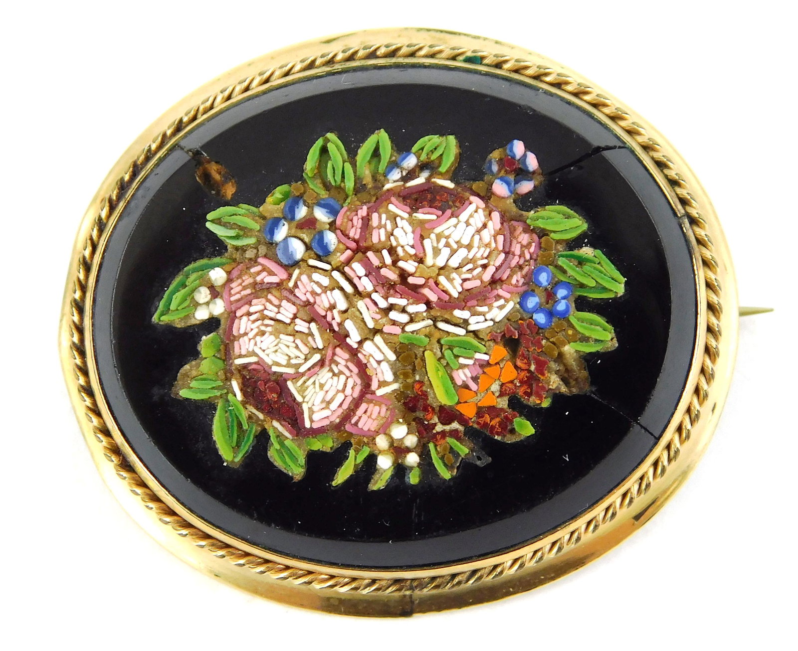 JEWELRY: 10K Micromosaic Pin of Floral Bouquet,: JEWELRY: 10K Micromosaic Pin of Floral Bouquet, contained in oval frame with rope edge tested 10K yellow gold, wear consistent with age and use, onyx is cracked in three places with some loss, 1 5/8" 