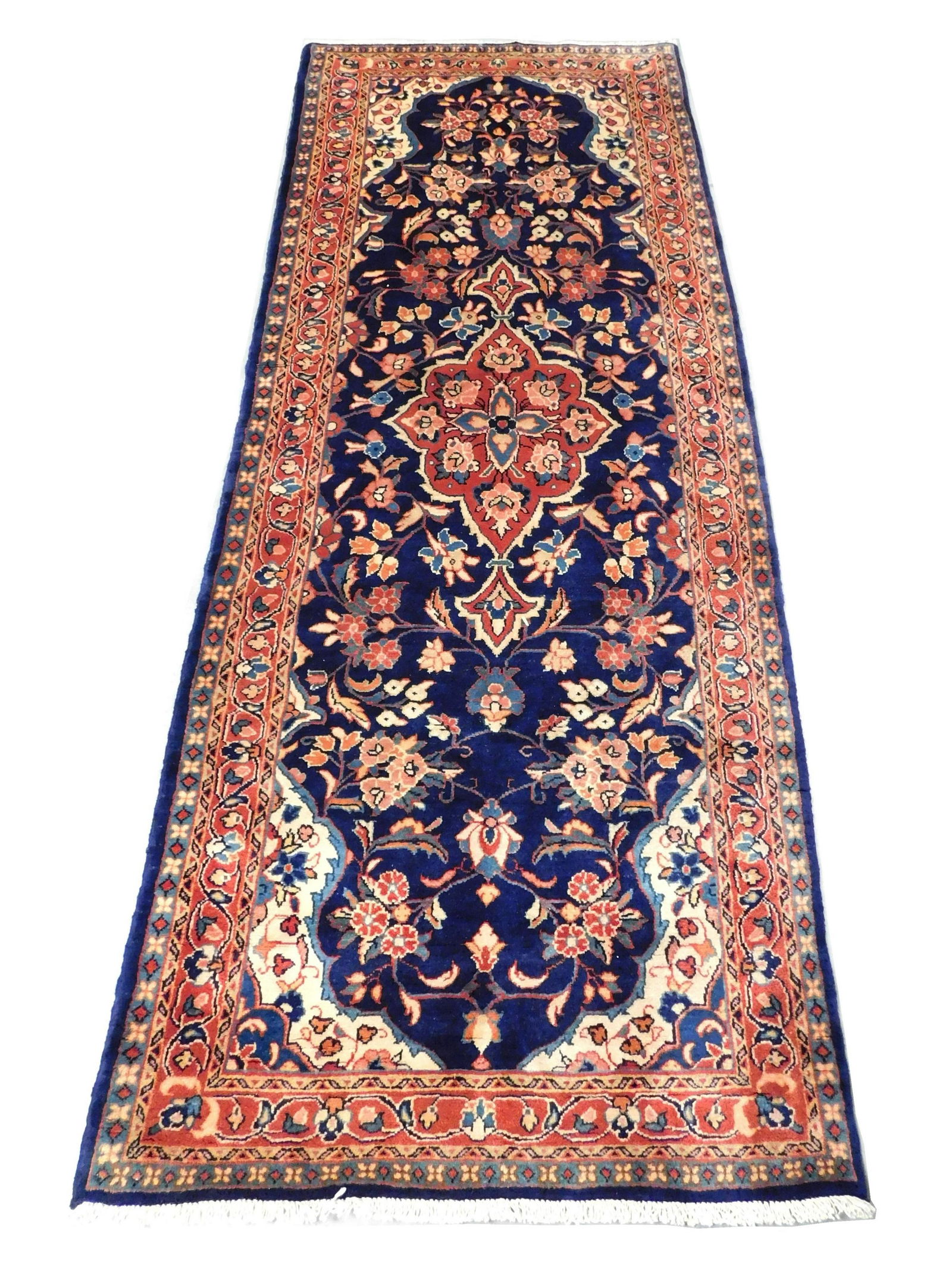 RUG: Persian, 9' 2" x 3' 7", 100% wool on cotton, rust: RUG: Persian, 9' 2" x 3' 7", 100% wool on cotton, rust medallion on blue field with rust border and cream corners, wear consistent with age and use.