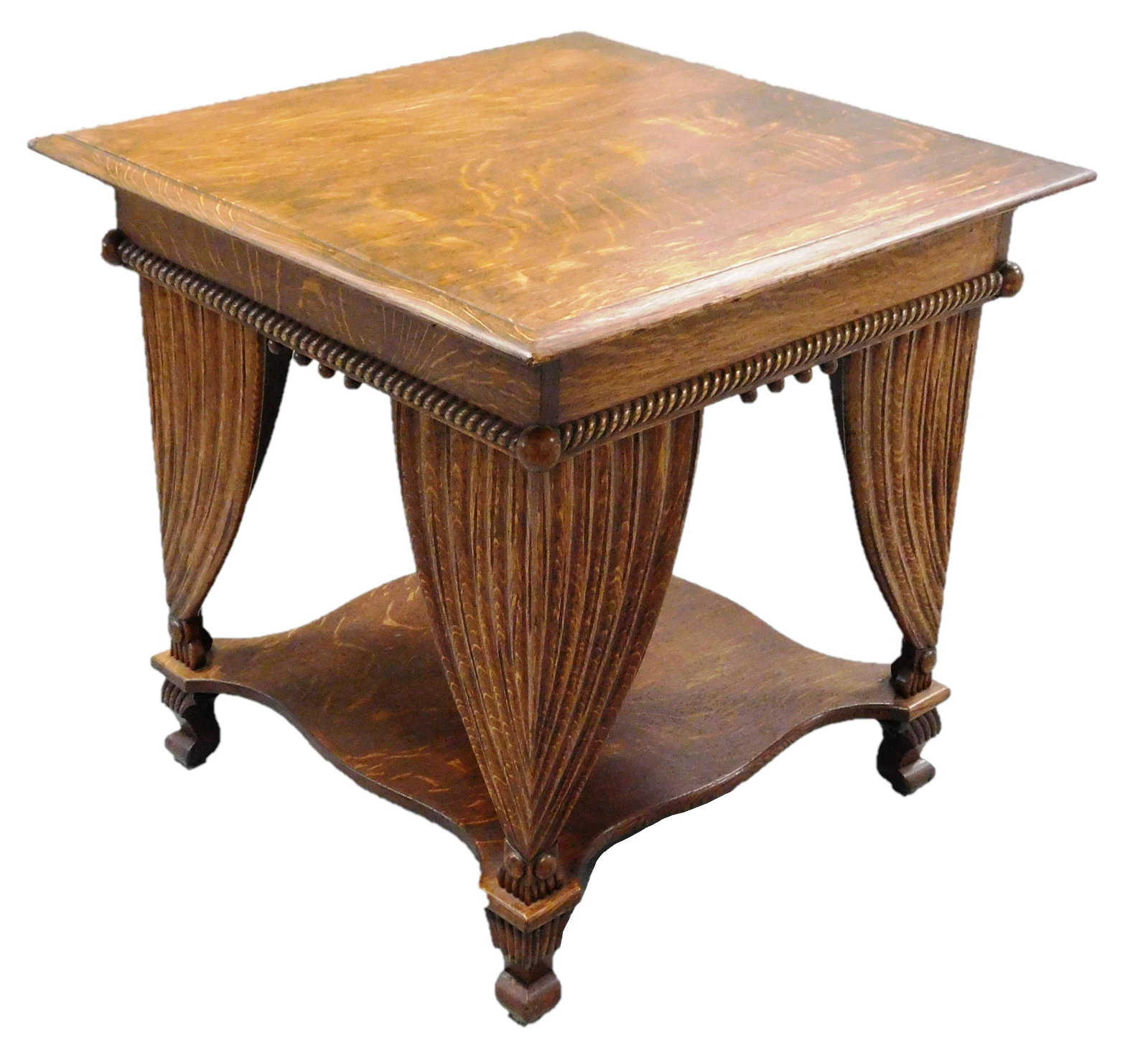 Center table with carved drapey to sides, mid-late 19th: Center table with carved drapey to sides, mid-late 19th C., oak, stretcher shelf, wear consistent with age and use, 29'' h. x 30'' w. x 29'' d. [PLEASE BRING APPROPRIATE ASSISTANCE FOR PICKUP DUE TO T