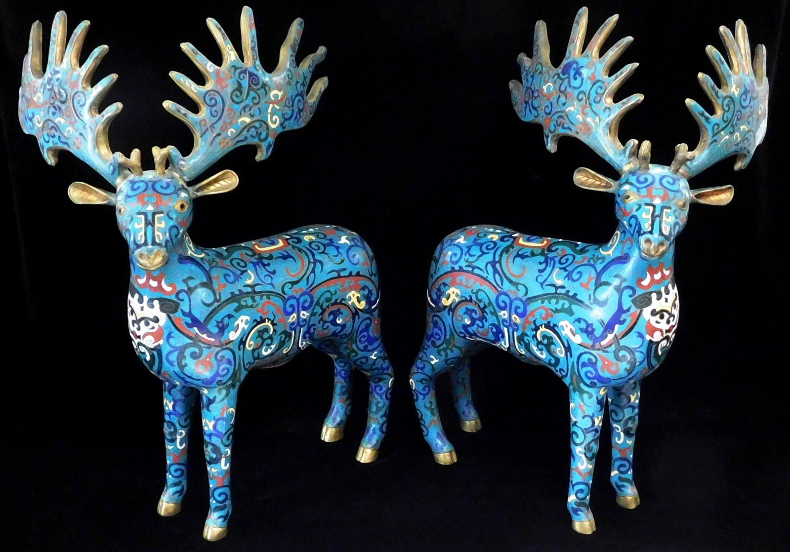 ASIAN: Pair of Chinese cloisonne stags, probably 20th: ASIAN: Pair of Chinese cloisonne stags, probably 20th C., polychrome scrolling foliate decoration on blue ground, wear consistent with age and use, including some cracks in solder joining antlers to t