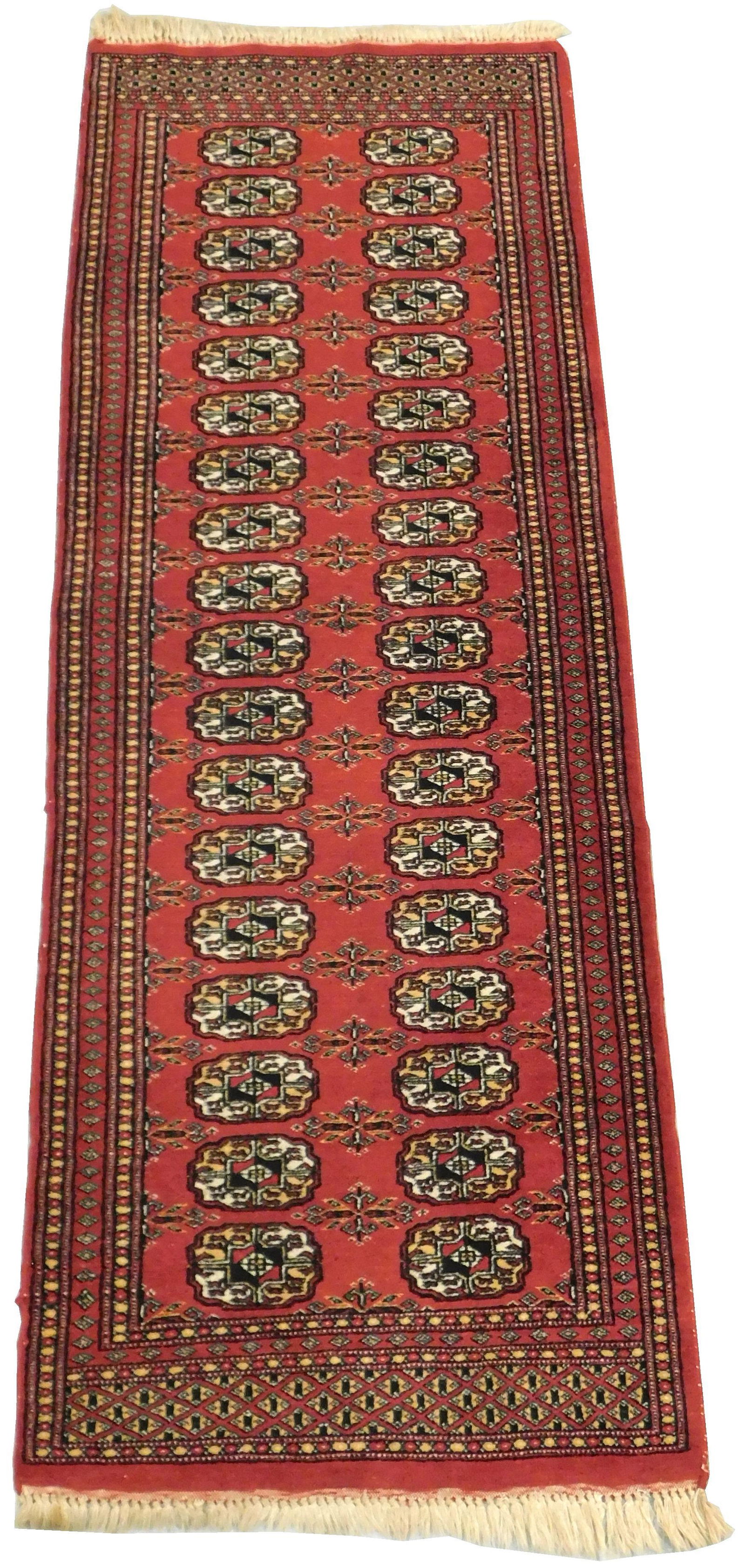 RUG: Modern Tekkee Bokhara runner, 6' 2" x 2' 1 1/2",: RUG: Modern Tekkee Bokhara runner, 6' 2" x 2' 1 1/2", 100% wool on cotton, two rows of small medallions, brick red, with black, white, and cream, wear consistent with age and use, including minor edge