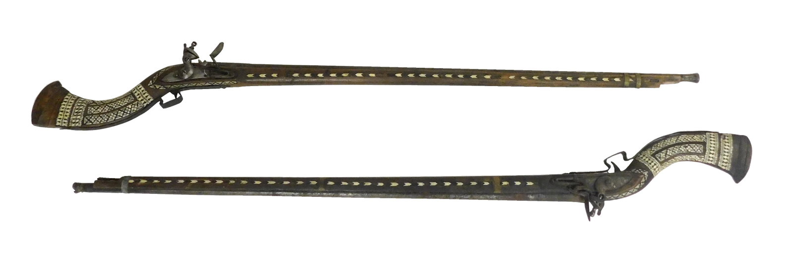 Pair of 19th C. Moroccan Camel Rifles, simplistic workmanship with camel bone inlay, same maker both: Pair of 19th C. Moroccan Camel Rifles, simplistic workmanship with camel bone inlay, same maker both rifles, flintlock mechanism, one stamped with the East India lion and date 1810, wear consistent wi