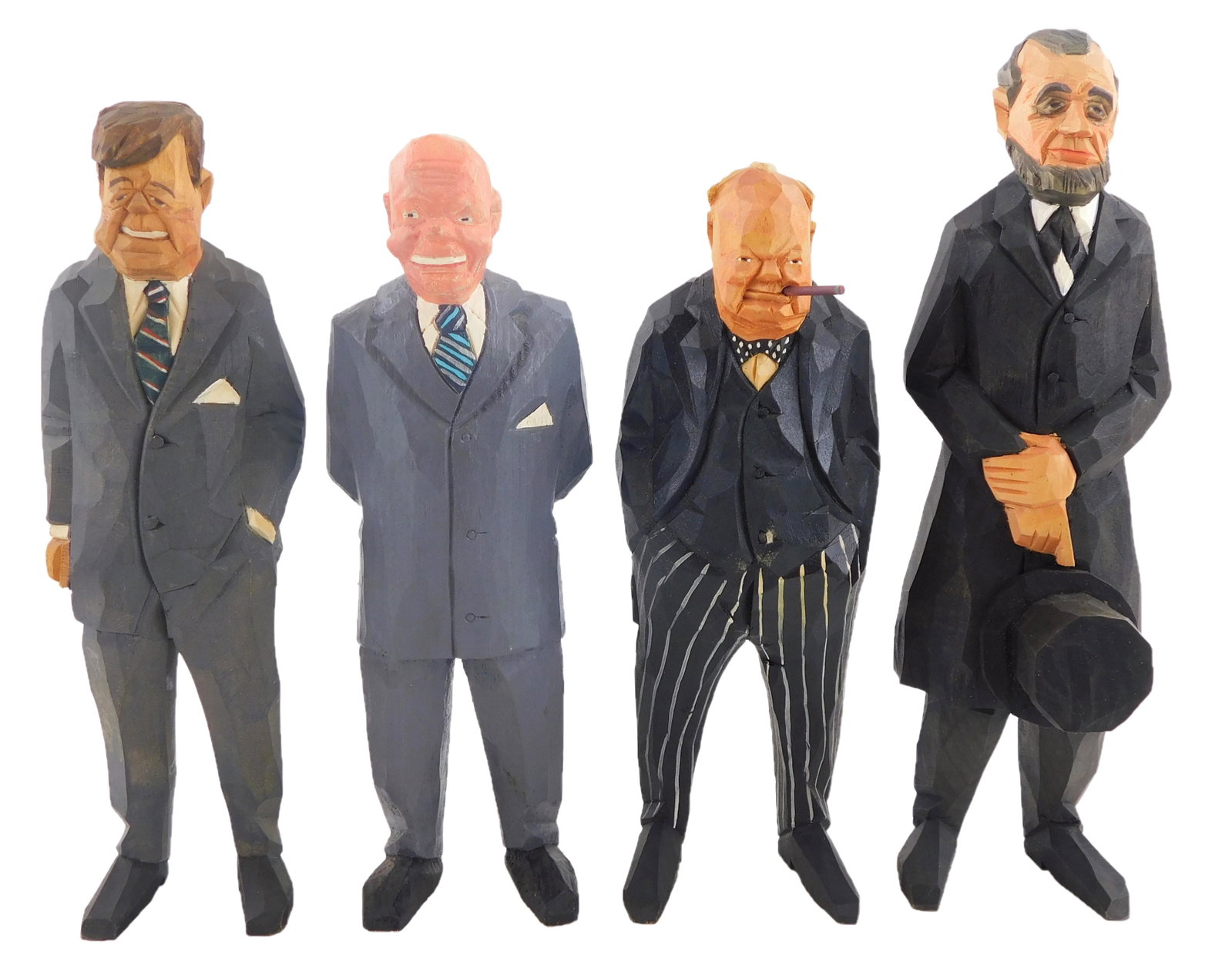 Four Gunnarsson (Sweden) hand carved wood political figures, mid-20th C.: Winston Churchill with: Four Gunnarsson (Sweden) hand carved wood political figures, mid-20th C.: Winston Churchill with cigar; Abraham Lincoln holding his hat; John F Kennedy, one hand in pocket; Eisenhower, hands clasped b