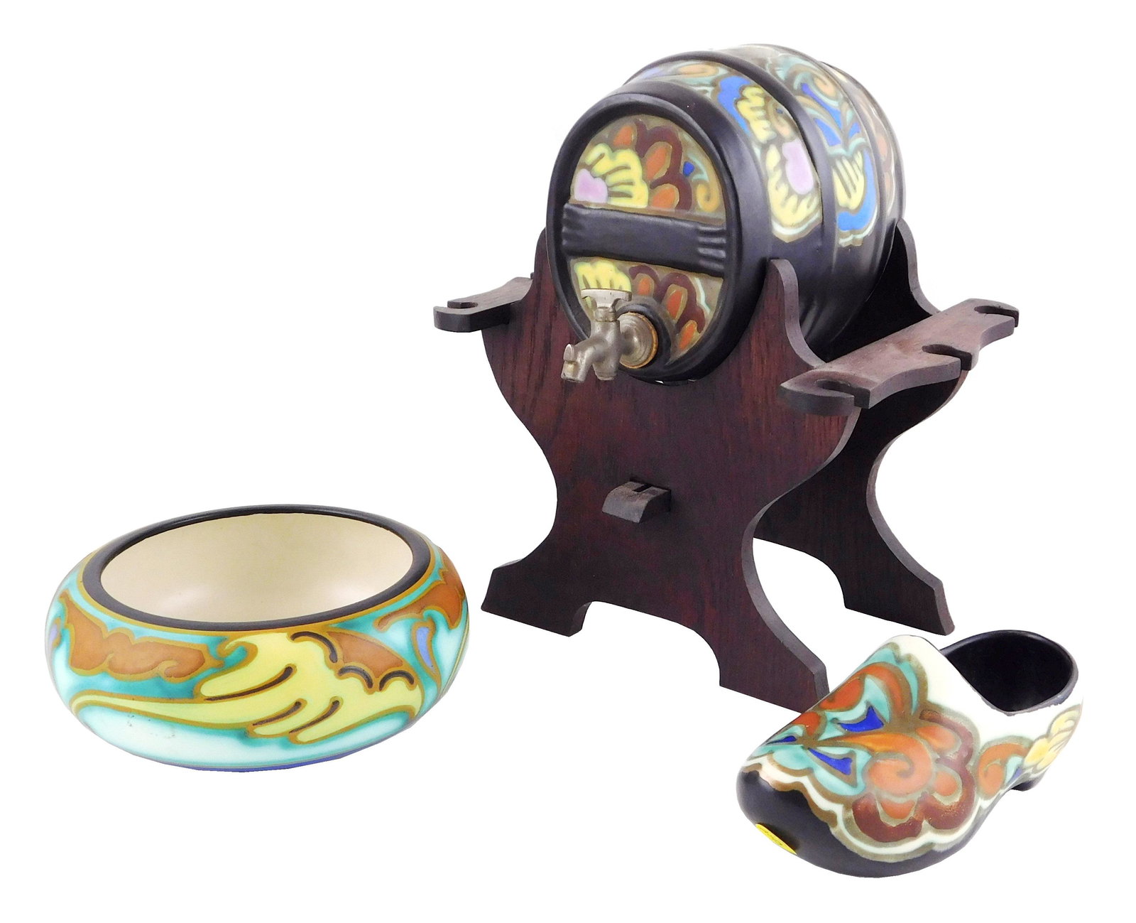 ART POTTERY: three pieces , Gouda, and one other, details include: Gouda keg on a wooden stand,: ART POTTERY: three pieces , Gouda, and one other, details include: Gouda keg on a wooden stand, missing stopper on top as well as glasses which attach to sides, floral pattern on both keg and stand,12