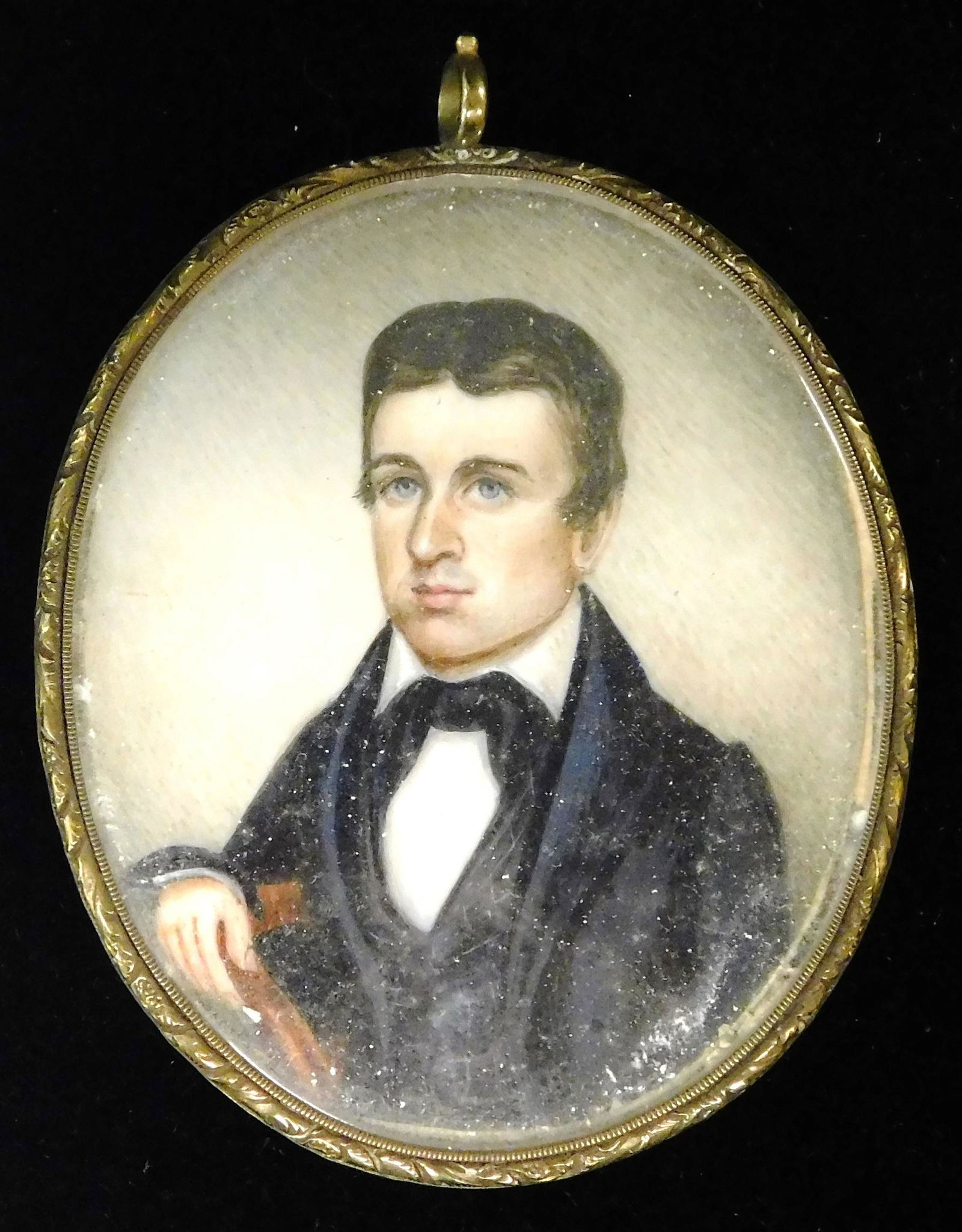 MINIATURE: Young man, oval support, seated in chain with Arman crest, blue eyes, dark hair with (1 of 2)
