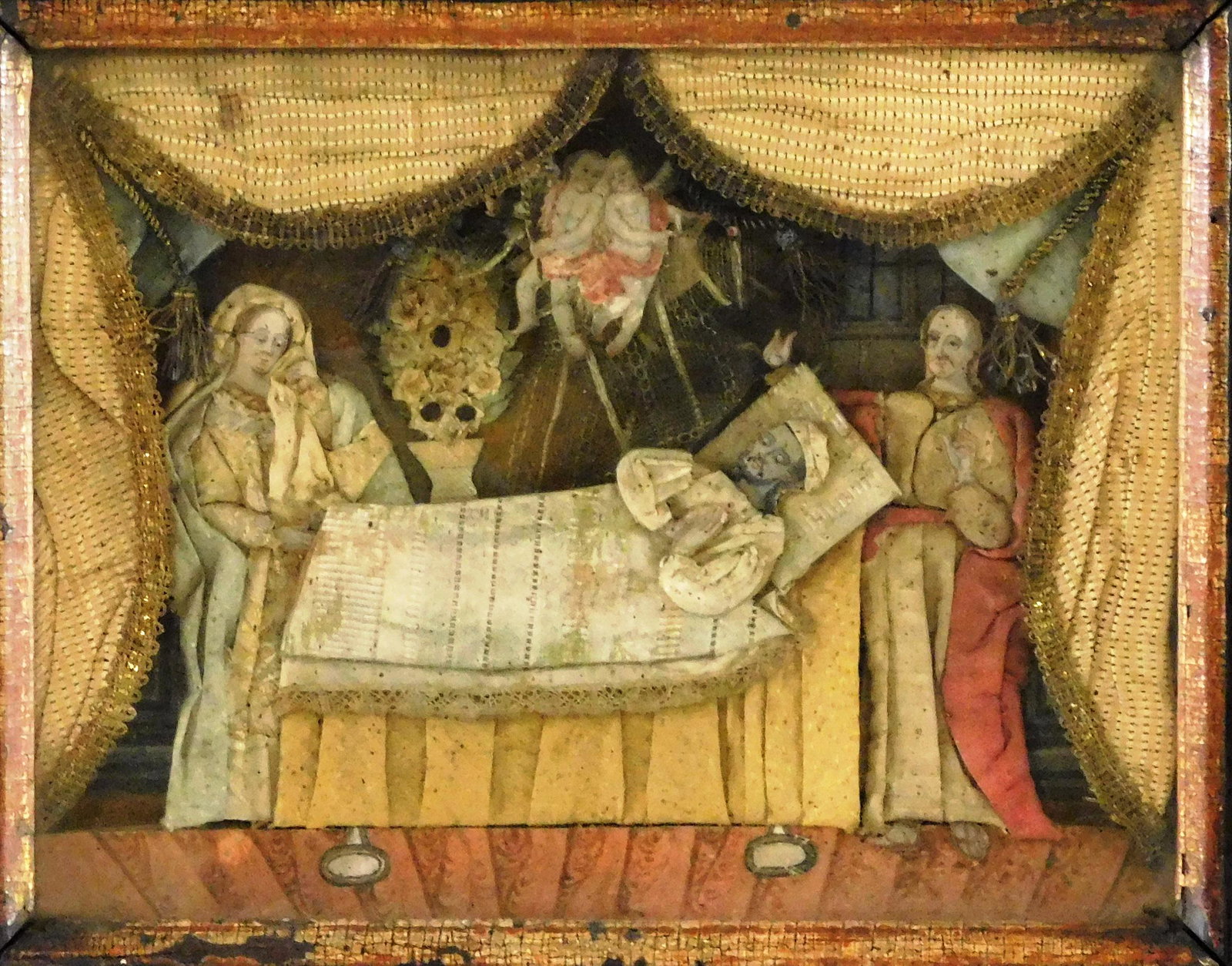 Fabric 3-D mourning vignette, 19th C., depicts people at bedside with angels above, surrounded by (1 of 2)