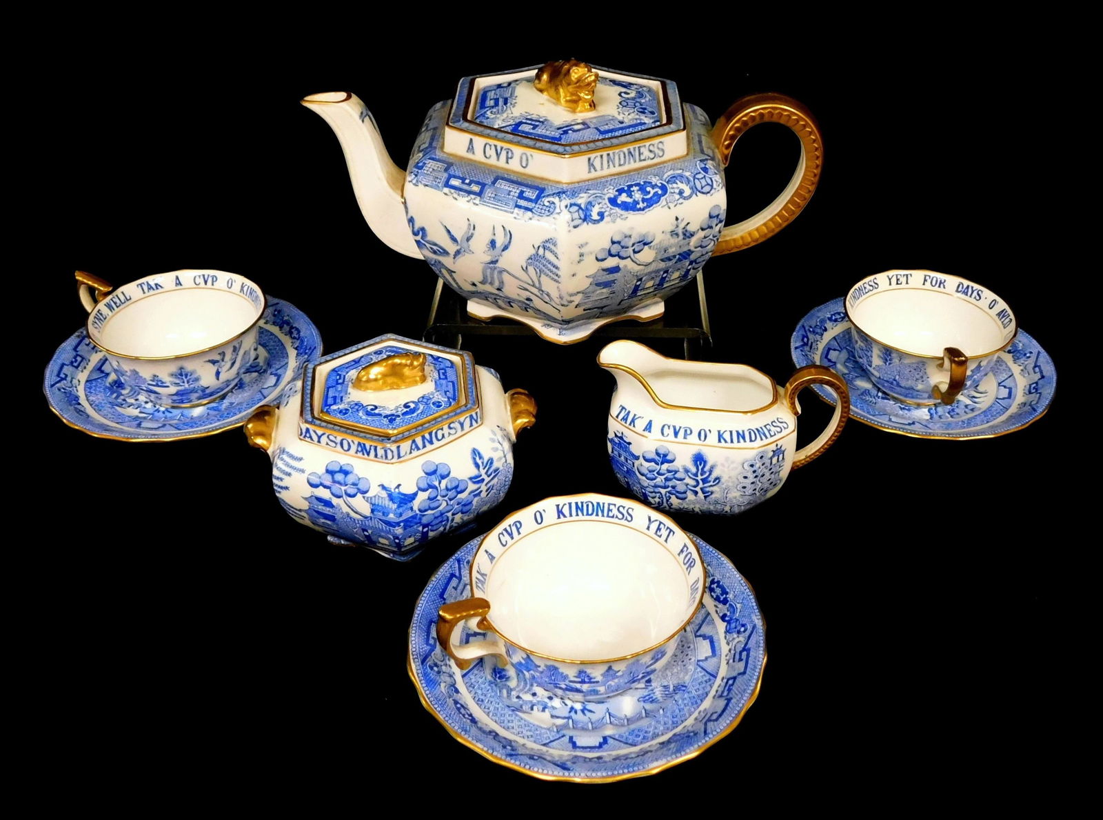 Copeland Spode tea set, 'blue willow' pattern, retailed by Tiffany and Co., nine pieces of blue and: Copeland Spode tea set, 'blue willow' pattern, retailed by Tiffany and Co., nine pieces of blue and white china with gilt accents including teapot, 7" diam., lidded sugar, creamer, crack near handle,